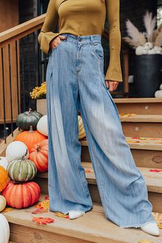 - These wide legged pants are a trendy option to add to your wardrobe! - Unlined chambray material - A waistline with an elastic back, belt loops, a hidden zip fly, and button closure - A functional five pocket cut - Pleated detail - An ultra relaxed silhouette that end in floor length frayed hemlines Trendy Faded Pants For Fall, Medium Wash Washed Pants For Fall, Spring Washed Wide-leg Jeans, Fall Light Wash Denim Wide Leg Pants, Fall Medium Wash Wide-leg Flare Jeans, Wide-leg Denim Blue Jeans For Fall, Wide-leg Denim Jeans For Fall, Dark Wash Denim Wide Leg Pants For Fall, Light Blue Wide Leg Denim Bottoms