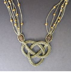 the necklace is made from rope and beads with two pendants on each strand,