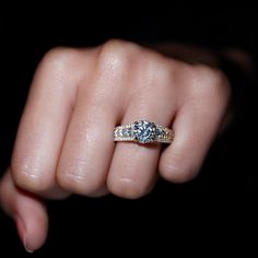 a woman's hand with a diamond ring on it