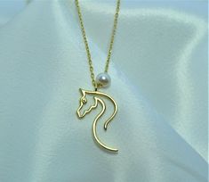 "10K 14K 18K Gold Horse Necklace, Design Horse Necklace, Equestrian Pendant, Handmade Necklace, Gift For Her, Horse Necklace With Pearls, Christmas Gift, Valentines Day Gift, Mothers Day Gift, Birthday Gift All jewelry in our collection are real solid gold and completely handmade accessories. The jewelry in our collection, which is an accessory with a bright and eye-catching beauty that will make others notice you and your loved ones in the environments you enter, is a great gift option to add v Classic Necklace With Horse Design For Gift, Formal Horse Design Pendant Jewelry, Elegant Formal Necklace With Horse Design, Gold Horse Design Pendant Necklace, Elegant Horse Design Pendant Jewelry, Elegant Horse Design Necklace As Gift, Elegant Necklace With Horse Design As A Gift, Classic Gold Jewelry With Horse Design, Elegant Round Jewelry With Horse Design