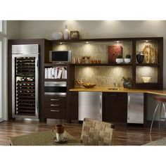 a kitchen with wooden flooring and built - in wine cooler