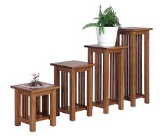 three wooden tables with one planter on top and the other end table below them