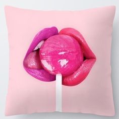 a pink and purple pillow with a lip on the tip of a lollipop