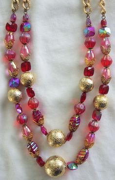 "Vintage Beaded Choker / Necklace: Two-Strand Pink & Red Glass with Gold Metal Accent Beads Unusual 1950s-1960s Pretty 50s-60s necklace, with gorgeous pink and red glass beads of various shapes and types with different sizes of round gold metal beads and chunky gold chain. Hook clasp; unmarked. This necklace is truly gorgeous--the beads sparkle and shimmer. 17\" long / 20.5\" long with extender...this is a choker." Vintage Red Jewelry For Celebrations, Red Vintage Jewelry For Celebrations, Vintage Beaded Necklace With Large Beads For Party, Vintage Beaded Necklace With Round Beads For Party, Vintage Beaded Necklaces With Large Beads For Festive Occasions, Vintage Round Beads Necklace For Party, Vintage Colorful Beaded Necklaces For Festive Occasions, Vintage Round Beaded Necklace For Party, Red Beaded Necklaces With Spacer Beads For Party