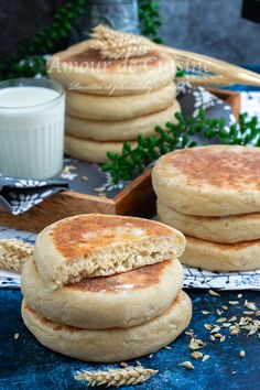 three pancakes stacked on top of each other next to a glass of milk and oatmeal