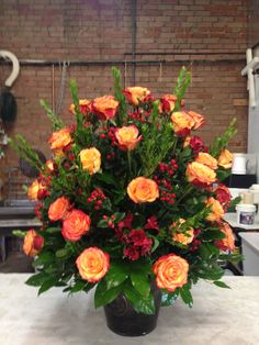 a vase filled with orange and red flowers