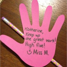 a pink hand with writing on it and two pencils next to it that says, kosher keep up the great work high five u miss m