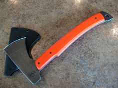 an orange and black knife sitting on top of a counter