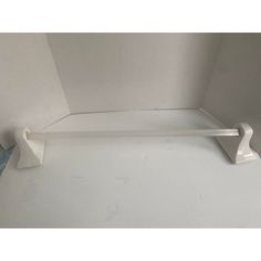 a white shelf sitting in the corner of a room