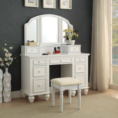 a white vanity with stool and mirror in a room