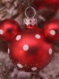 a mickey mouse ornament hanging from a christmas tree