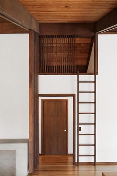 an empty room with wooden floors and stairs