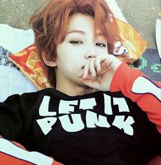 a person with red hair laying on the ground