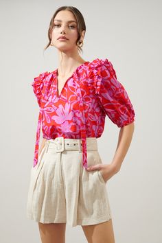 Abstract meets tropical. A fun-loving combo of a print takes on the Noche Blouse. Ruffle trim connects voluminous puff sleeves to a relaxed fit, trapeze bodice. A split neckline with a flattering tie detail sits at the center neckline. Easily style the blouse tucked into your favorite trousers or wear it untucked over your favorite breezy shorts.- Lightweight- Trapeze frame- Tie neck - Elastic cuffs- Color: Pink RedSize + Fit - Model is 5'9" and wearing size XS- Measurements taken from size S - Hyunjin Photoshoot, Summer 25, Straykids Hyunjin Photoshoot, Straykids Hyunjin, Tie Neck Blouse, Fun Loving, Puff Sleeve Top, Pink Blouse, Tie Neck