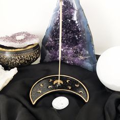 an amethorate and other items sit on a black cloth with gold accents