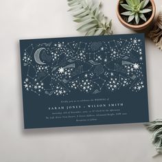 an image of a wedding card with stars and the moon on it next to some succulents