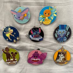 six pin badges with cartoon characters on them