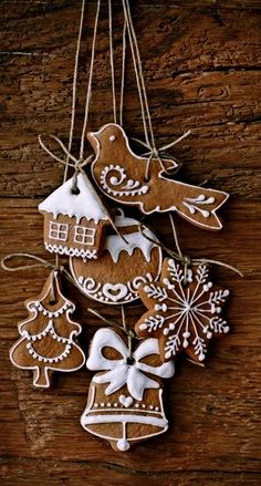 gingerbread christmas ornaments hanging on a wooden table