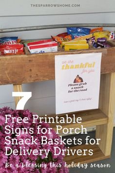 a wooden table topped with lots of snacks and flowers next to a sign that says free printable signs for porch snack baskets for delivery