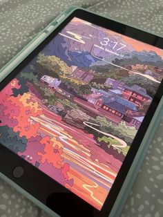 the tablet is displaying an image of a colorful city on it's display screen