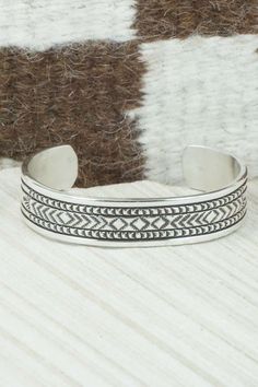 This sterling silver and bracelet was made by Navajo silversmith Bruce Morgan. The inside is signed B. Morgan and stamped sterling.Size: 5 1/4" (will fit up to a 6 3/8" wrist)Gap: 1 1/8"Width: 1/2"Free shipping on all orders! We ship with USPS and always include tracking. All orders ship within a day of payment.Returns are accepted up to 30 days after you receive your order. Just send us a message. Our shop offers cash back or store credit. The item must be returned in new condition. Bohemian Antique Silver Sterling Silver Bracelet, Bohemian Antique Sterling Silver Bracelet, Adjustable Silver Southwestern Bangle, Bohemian Sterling Silver Bracelet With Oxidized Finish, Adjustable Southwestern Silver Bangle, Adjustable Silver Southwestern Bracelet, Southwestern Sterling Silver Cuff Bracelet In Silver, Southwestern Sterling Silver Cuff Bracelet, Artisan Sterling Silver Bracelet With Etched Details