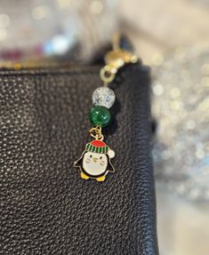 a black purse with a christmas charm on it