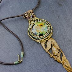 a necklace that has been decorated with flowers and beads