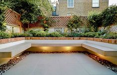 an outdoor seating area with lights and plants