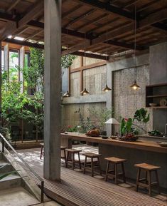 an outdoor dining area with wooden tables and stools