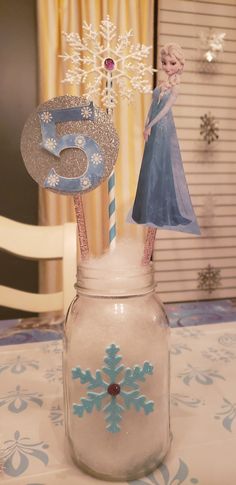 there is a glass jar with some decorations in it