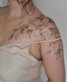 a woman with a flower tattoo on her shoulder