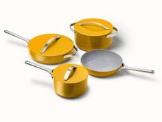 three yellow pots and pans on a white background