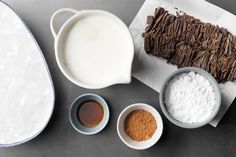 ingredients for chocolate cake laid out on top of each other, including milk and cocoa