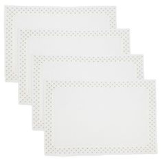 four white place mats with dots on them