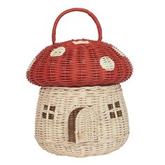 a wicker purse with a red mushroom on the front and white mushrooms on the back