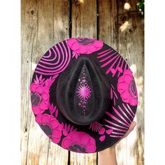 Halloween hat Brim is about 3.75" wide  Content: Vegan Suede Adjustable to fit your head better if needed  Elevate your style with this stunning hand-painted wide-brim fedora, crafted from luxurious vegan suede in a Vibrant Pink and Black palette. This one-of-a-kind piece is adorned with intricate designs featuring a flowers and vines winding gracefully around the crown, celestial stars, delicate leaves, The Sun and  phases of the moon. Each flower is meticulously painted with thick, textured st Halloween Costume Hats, Hat Halloween Costume, Black Palette, Pink Flower Crown, Celestial Stars, Halloween Hat, Suede Hat, Crown Hat, Festival Hat