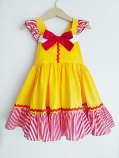 Hand made with love french fries fast food restaurant Cosette dress featuring flutters straps that ties into a bow at the back. Stretchable back, full twirly ruffled skirt. Perfect for themed birthday parties and photoshoot. or just as an outfit for a trip to her favourite french fries place for a meal. Handmade to order from size 1t to 8t. Please refer to the sizing chart provided for the size references. Care instructions: Handwash cold with mild soapy water and hang dry. Iron on light settings. Due to the handmade nature of this product, we do not accept returns or refunds unless there is a manufacturing error by us. Thank you for viewing our listing, have a great day! Yellow Ruffled Sundress For Party, Yellow Ruffled Party Sundress, Fun Red Ruffled Dress, Red Ruffled Dresses For Playtime, Fun Sleeveless Dress With Ruffles, Yellow Birthday Dress For Summer, Yellow Summer Birthday Dress, Fun Ruffled Dresses For Birthday, Fun Ruffle Dress For Birthday