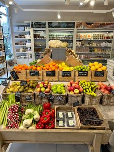 an assortment of fruits and vegetables on display in a grocery store