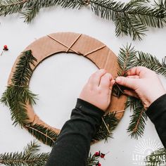 someone is making a wreath out of cardboard