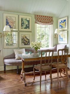 a dining room table with chairs and a bench in front of it, next to a window