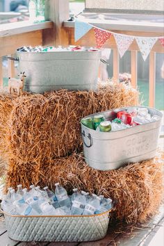 hay bales stacked on top of each other with coolers and drinks in them