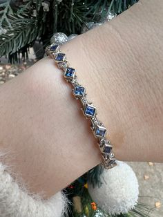 This exquisite Sapphire and Diamond Hinge Bangle is crafted from 18kt white gold, featuring 0.18ct natural diamonds and 12 glimmering blue sapphire stones. An elegant and timeless piece, it will add a touch of luxury to any ensemble. -18kt White Gold-0.18ct Natural Diamonds-12 Natural Blue Sapphires-7.5 in.Item 111-00134 Luxury Elegant Bangle With Natural Stones, Elegant Luxury Hinged Bangle, Elegant Sapphire Bangle Bracelet, Luxury Sapphire Diamond Bracelet With Gemstones, Luxury Blue Sapphire Bracelets, Luxury Sapphire Bangle Bracelet, Luxury Sapphire Diamond Bracelet With Accents, Luxury Sapphire Briolette Jewelry, Sapphire Stones