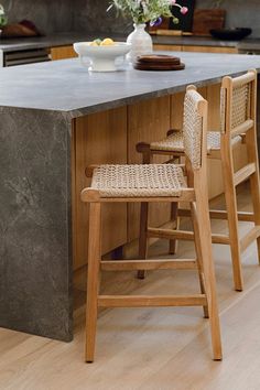 a kitchen island with two stools in front of it