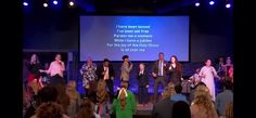 a group of people standing on top of a stage