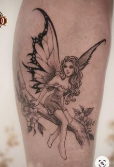 a tattoo with a fairy sitting on top of it's leg and holding onto the arm