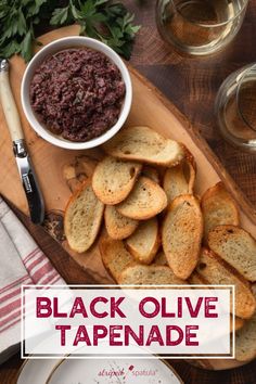 black olive tapenade on a wooden cutting board with bread