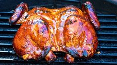 a close up of a chicken on a grill