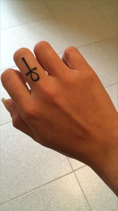 a person's hand with a small tattoo on it