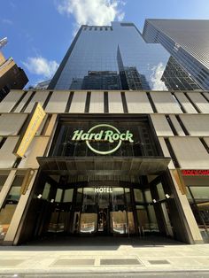 the entrance to hard rock hotel in new york city, with skyscrapers in the background