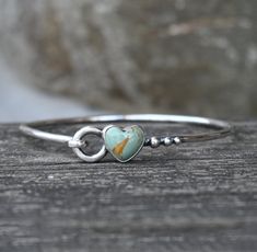 🌟PLEASE READ the following description before making your purchase. Note measurements and size reference photos. 12mm green American mined Kingman turquoise is set on a hand formed oblong 10 gauge (2.6mm) sterling silver bangle with eye hook closure. ♥ PLEASE measure your wrist with a soft tape measure or string at the smallest part (between your hand and wrist bone). Select that measurement from the DROP DOWN MENU on the right. I will make the proper adjustments to ensure a comfortable fit. Handmade Turquoise Heart Bracelet As A Gift, Handmade Turquoise Heart Bracelet As Gift, Handmade Turquoise Heart Bracelet For Gift, Turquoise Sterling Silver Bracelet For Anniversary, Turquoise Sterling Silver Bracelets For Anniversary, Handmade Green Sterling Silver Bangle, Green Sterling Silver Bangle As Gift, Gift Green Sterling Silver Bangle, Green Sterling Silver Bangle, Perfect As A Gift